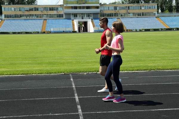 Young people jogging on stadium