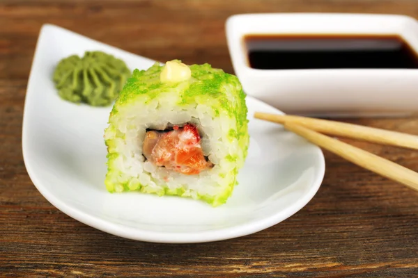 Roll with sauce and sticks on wooden table close up