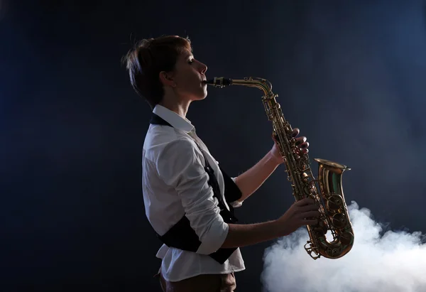 Attractive woman plays saxophone