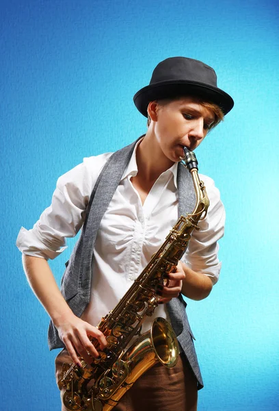 Pretty woman plays music on saxophon
