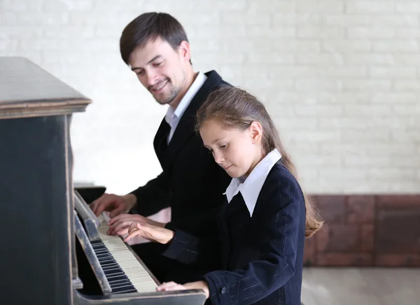 Teacher trains to play piano girl