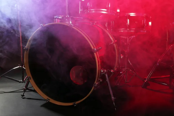 Drum set in smoke on a stage