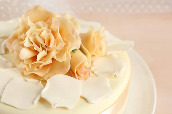 Cake with sugar paste flowers, on light background