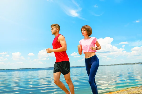 Young people jogging on beach