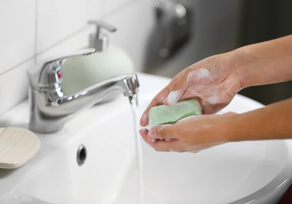 Washing of hands with soap under running water