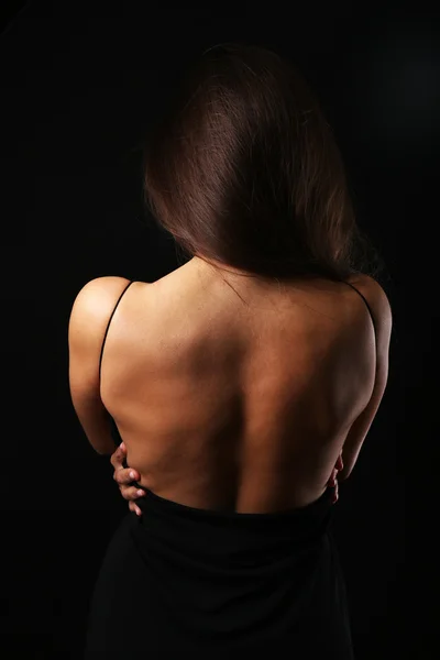 View on woman\'s back in open dress, close-up