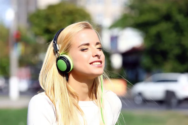 Young woman listening to music outside