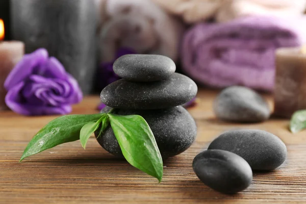 Candles with flowers, towels and pebbles