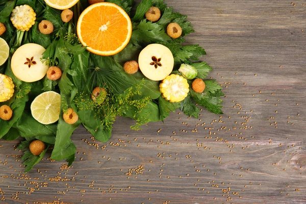 Beautiful designed bouquet of fruits and vegetables on wooden background, close up