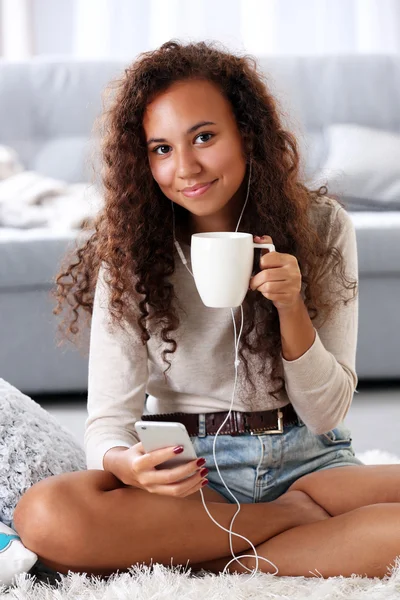 Beautiful girl listening music by headphones