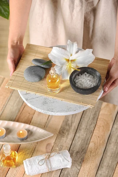 Hands with tray of spa products