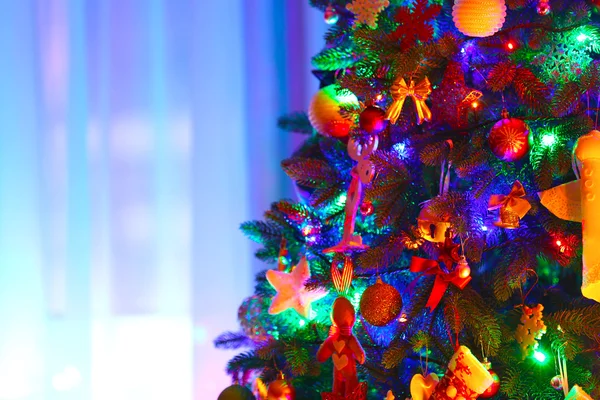 Christmas tree in a room on window background