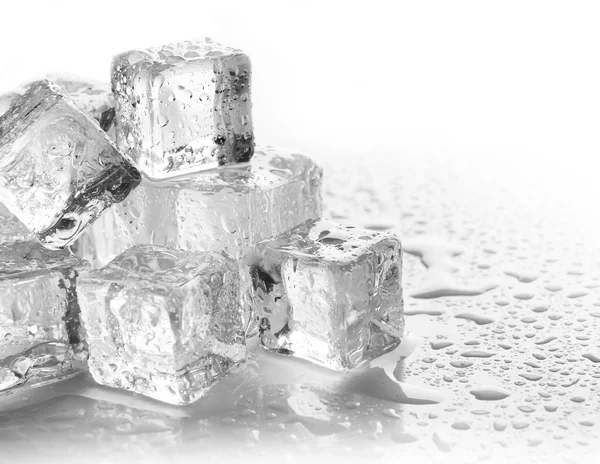 Melting ice cubes on grey background, close up
