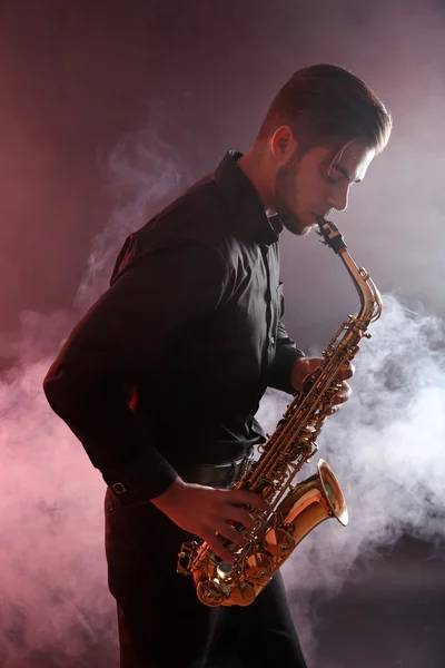 Young man professionally plays sax