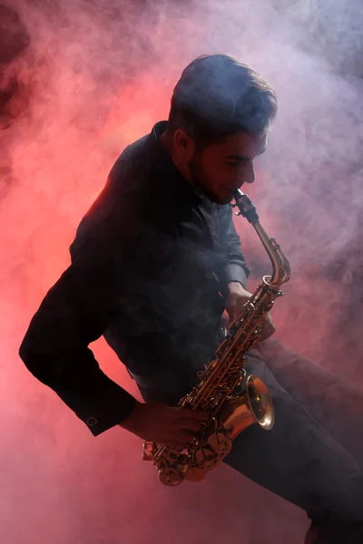 Young man professionally plays sax