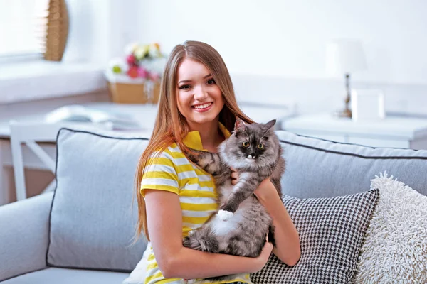 Young woman with cat at home