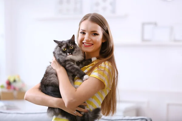 Young woman with cat at home