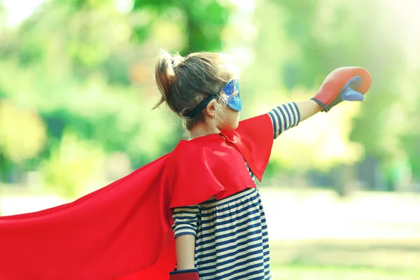 Cute little girl dressed as superhero