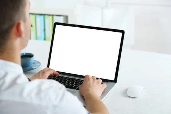 Man working with laptop in office