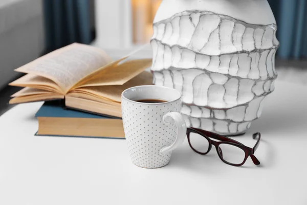 Cup of coffee with books