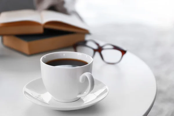 Cup of coffee with books