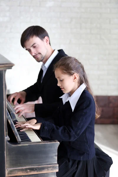 Teacher trains to play piano girl