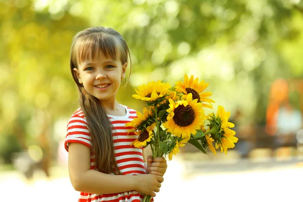 Little girl with sunflowers