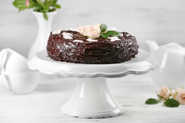 Chocolate cake decorated with flowers on the table