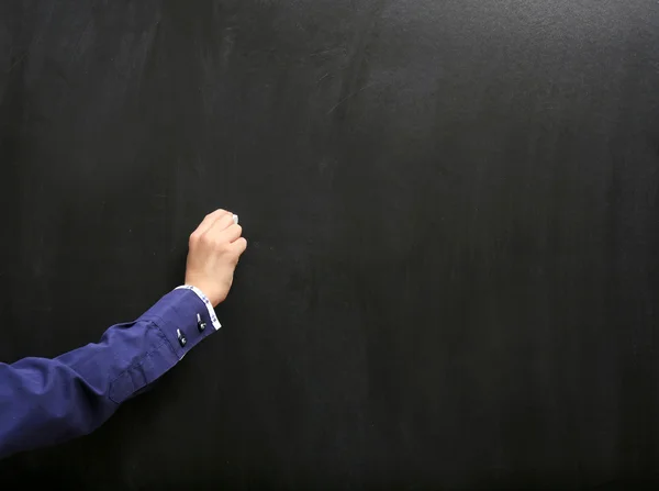 Vie hand writing at the clean blackboard