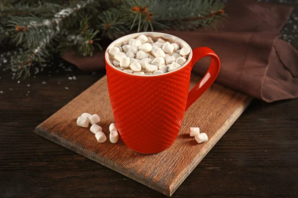 A cup of tasty cocoa and marshmallow on the table