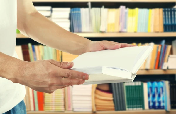 Male hands holding open book