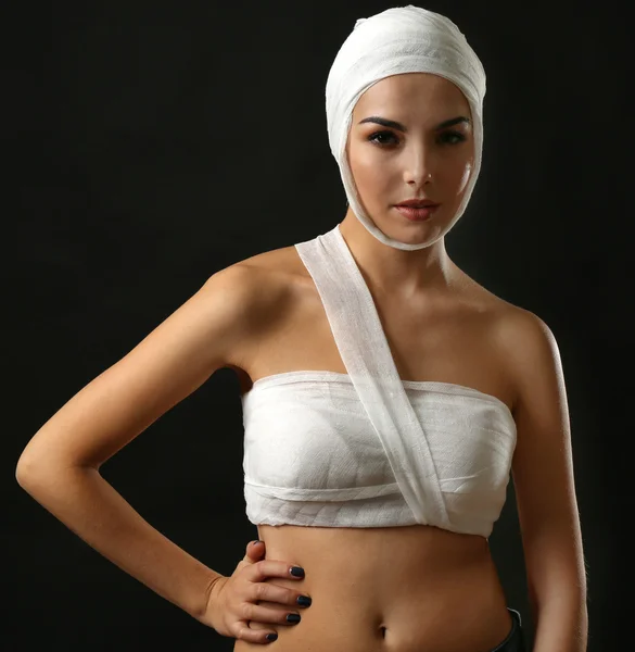 Woman with gauze bandage on her head and chest
