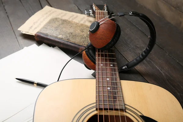 Acoustic guitar, headphones, musical notes