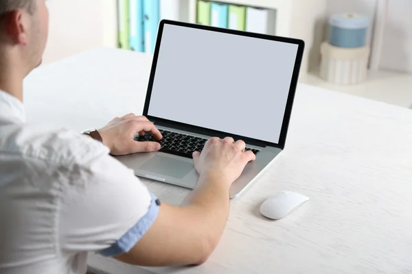 Man working with laptop in office