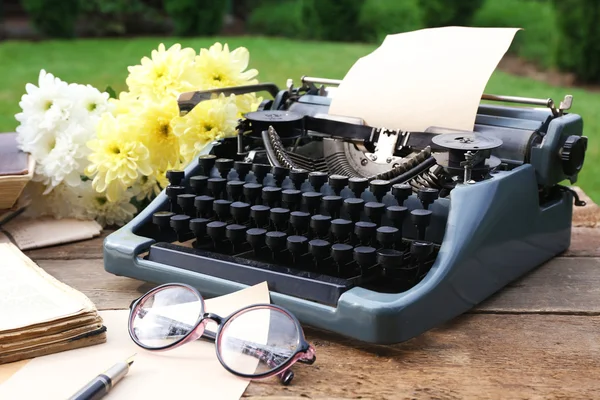 Vintage black typewriter with old books