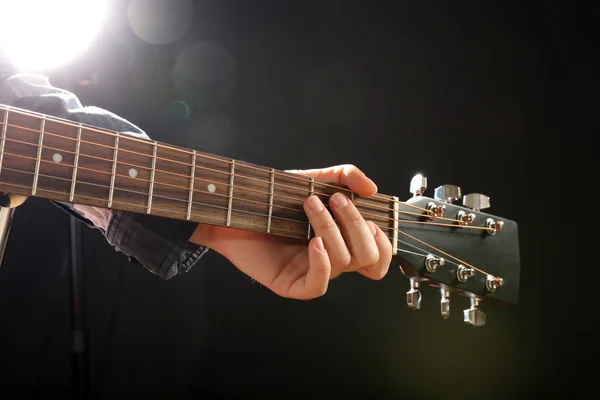 Guitars neck in musician hands