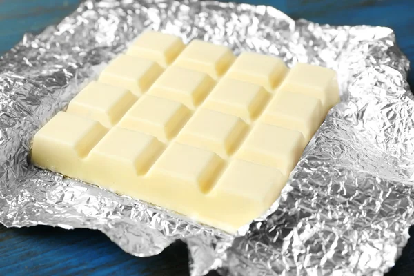 White Chocolate bar in foil  on gray background