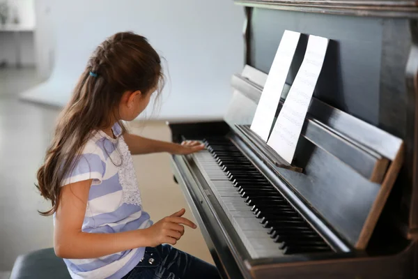 Girl studding to play piano