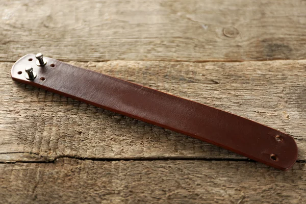 Leather bracelet on wooden background