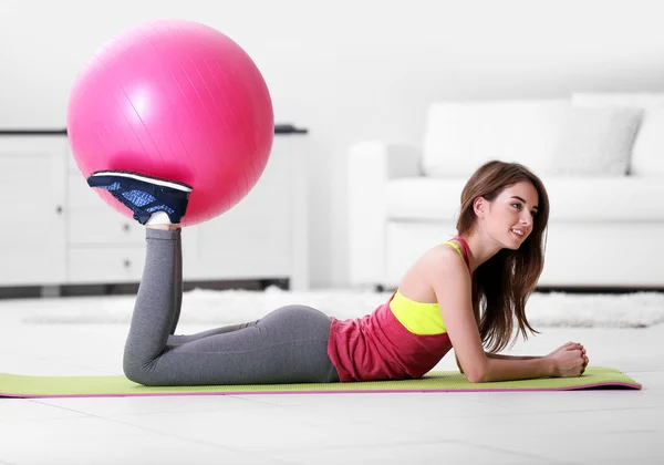 Girl doing exercises with fit ball