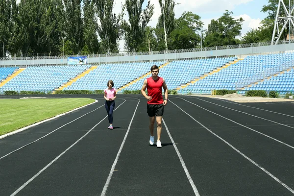 Young people jogging on stadium