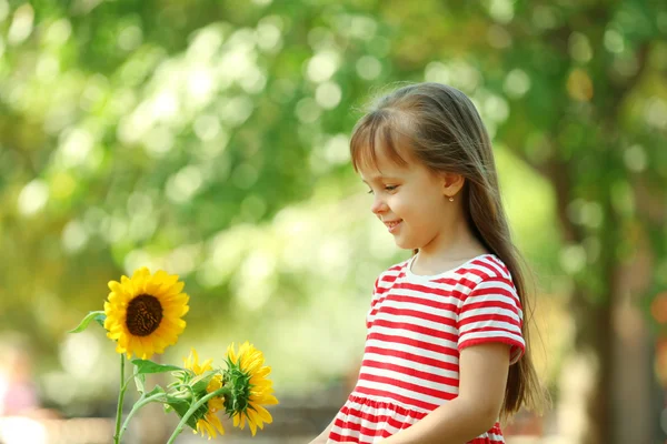 Little girl with sunflowers