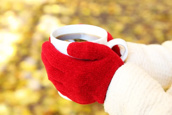 Woman holding cup of hot beverage