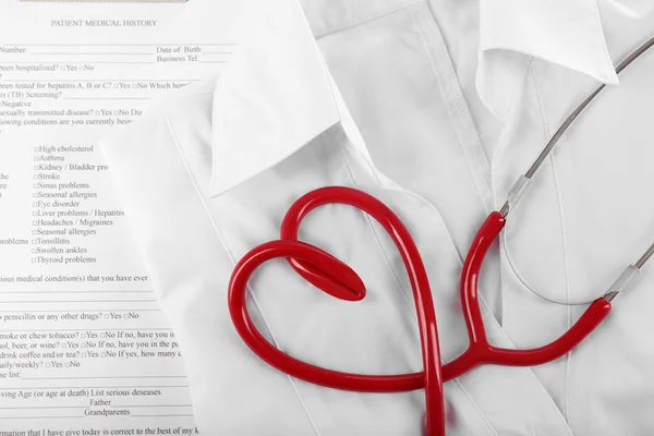 Red stethoscope, medical record and uniform