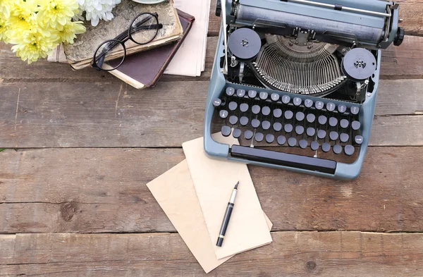 Vintage black typewriter with old books