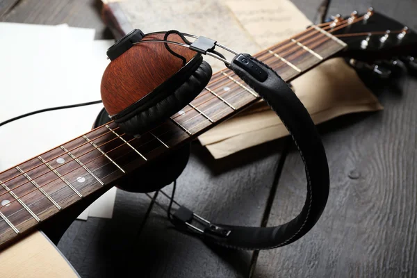 Acoustic guitar, headphones, musical notes