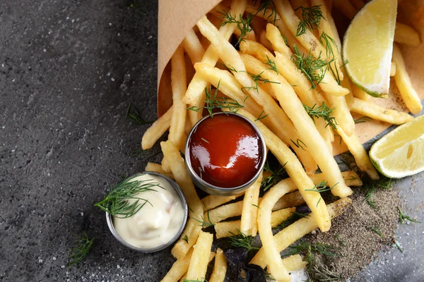 French fries in bag with sauce, lime and spice