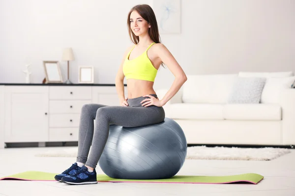Girl doing exercises with fit ball