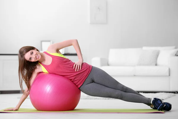 Girl doing exercises with fit ball