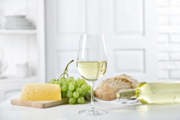 Still life of wine, grape, cheese and bread